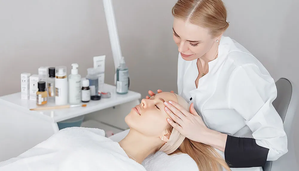 esthetician working on facial